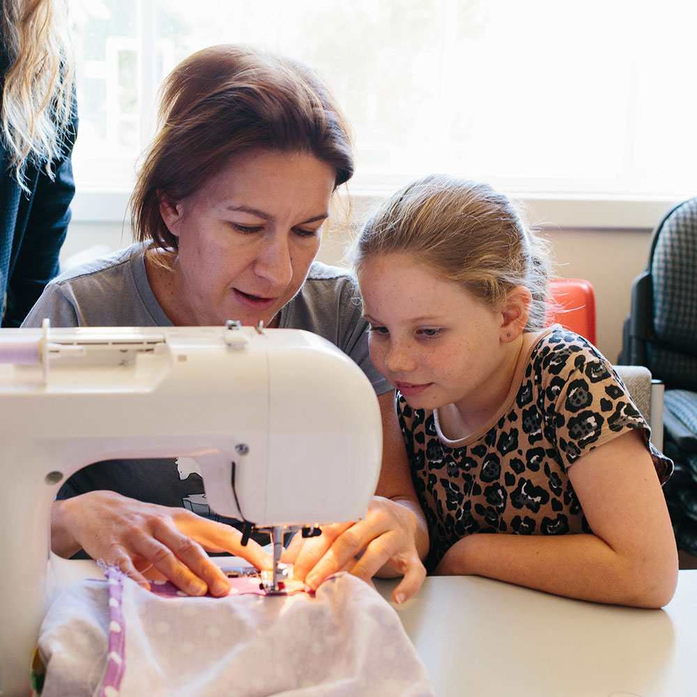 Anna Woman sewing with child